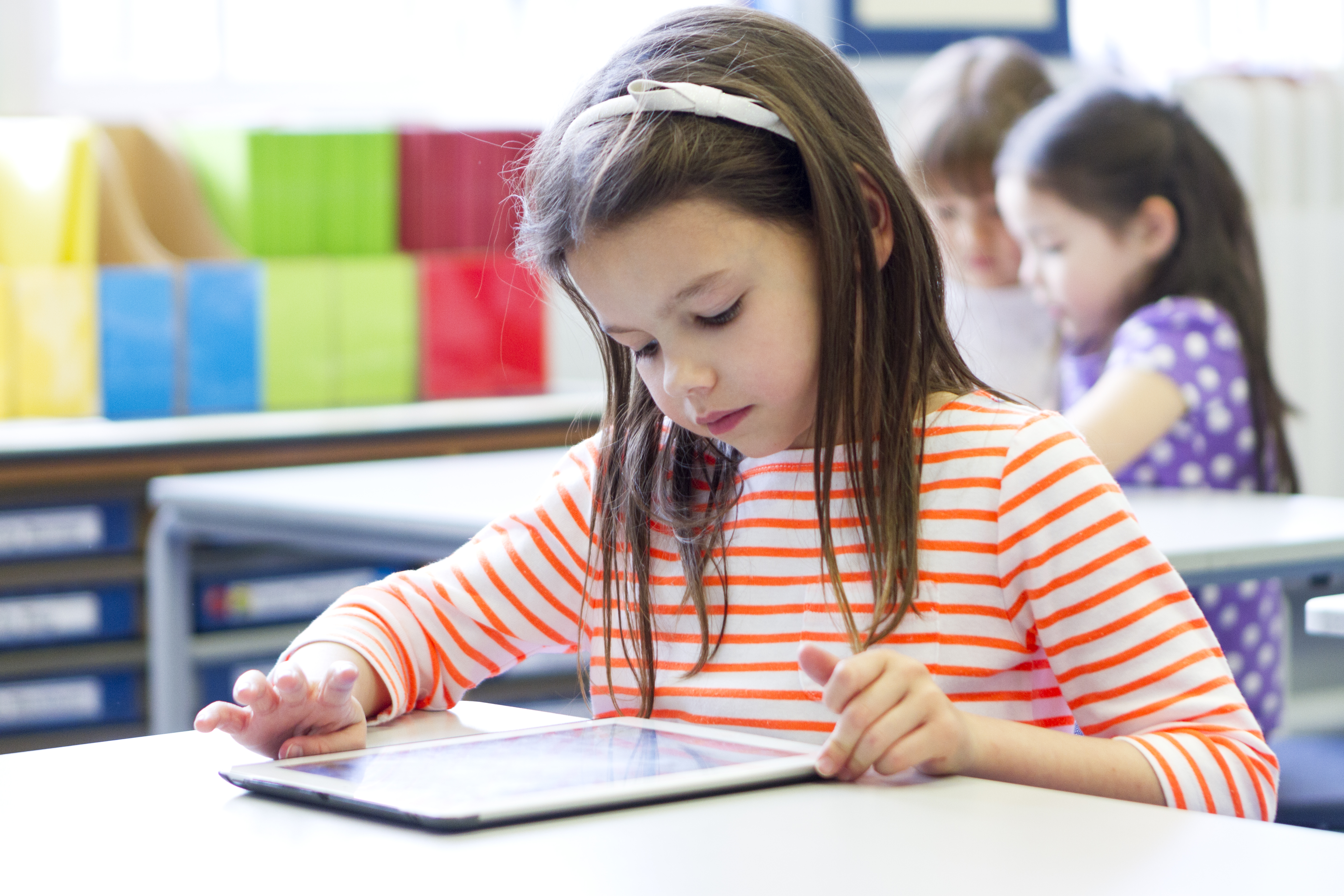 A young girl concentrating happily in class