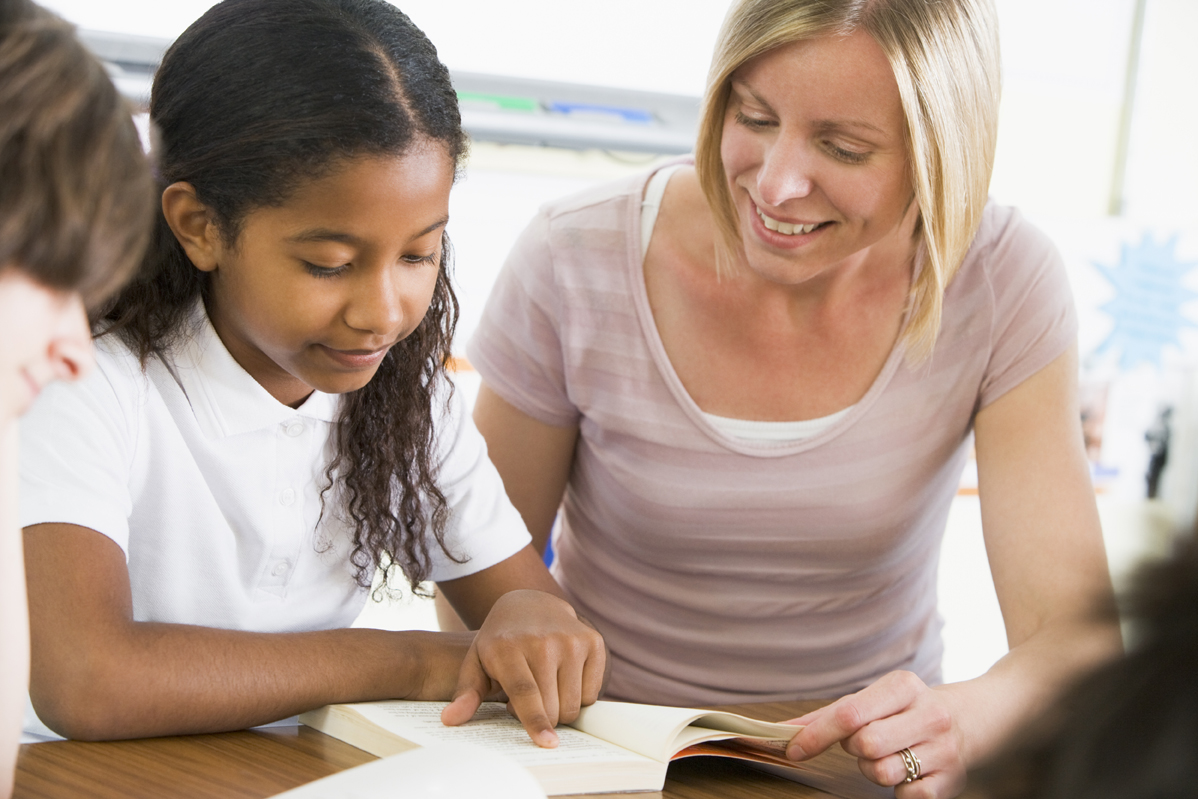 A teacher and student working together at a desk